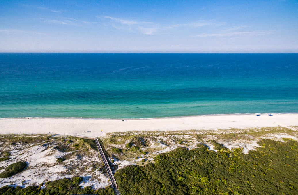 Aerial view of sugar-white beach and emerald Gulf water