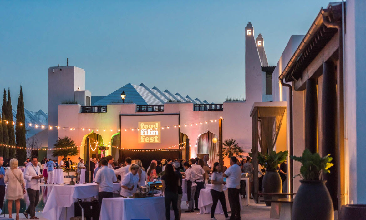 Guests dining in an outdoor courtyard at dusk
