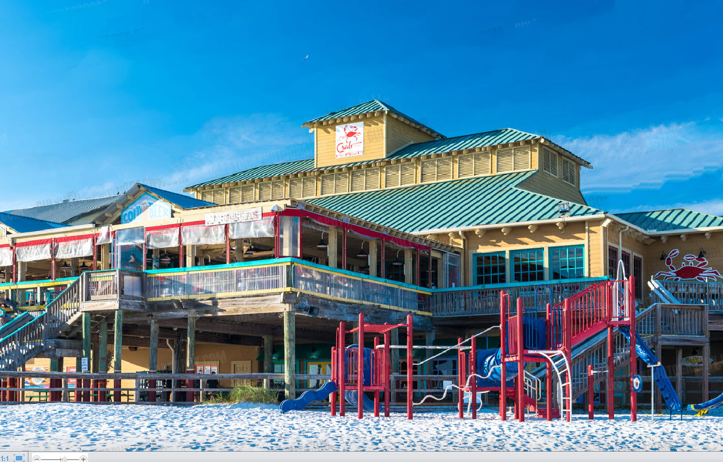 Beachfront restaurant with colorful outdoor play structures