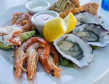 Seafood platter with shrimp, oysters, and lemon