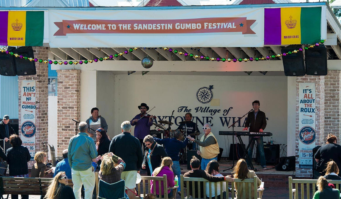 Live band performing for a crowd at an outdoor festival