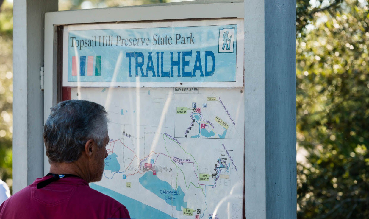 Visitor reading a nature trail map