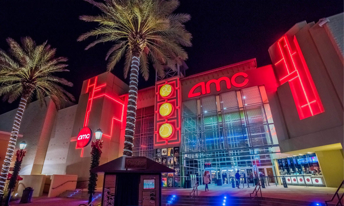 Illuminated movie theater entrance at night