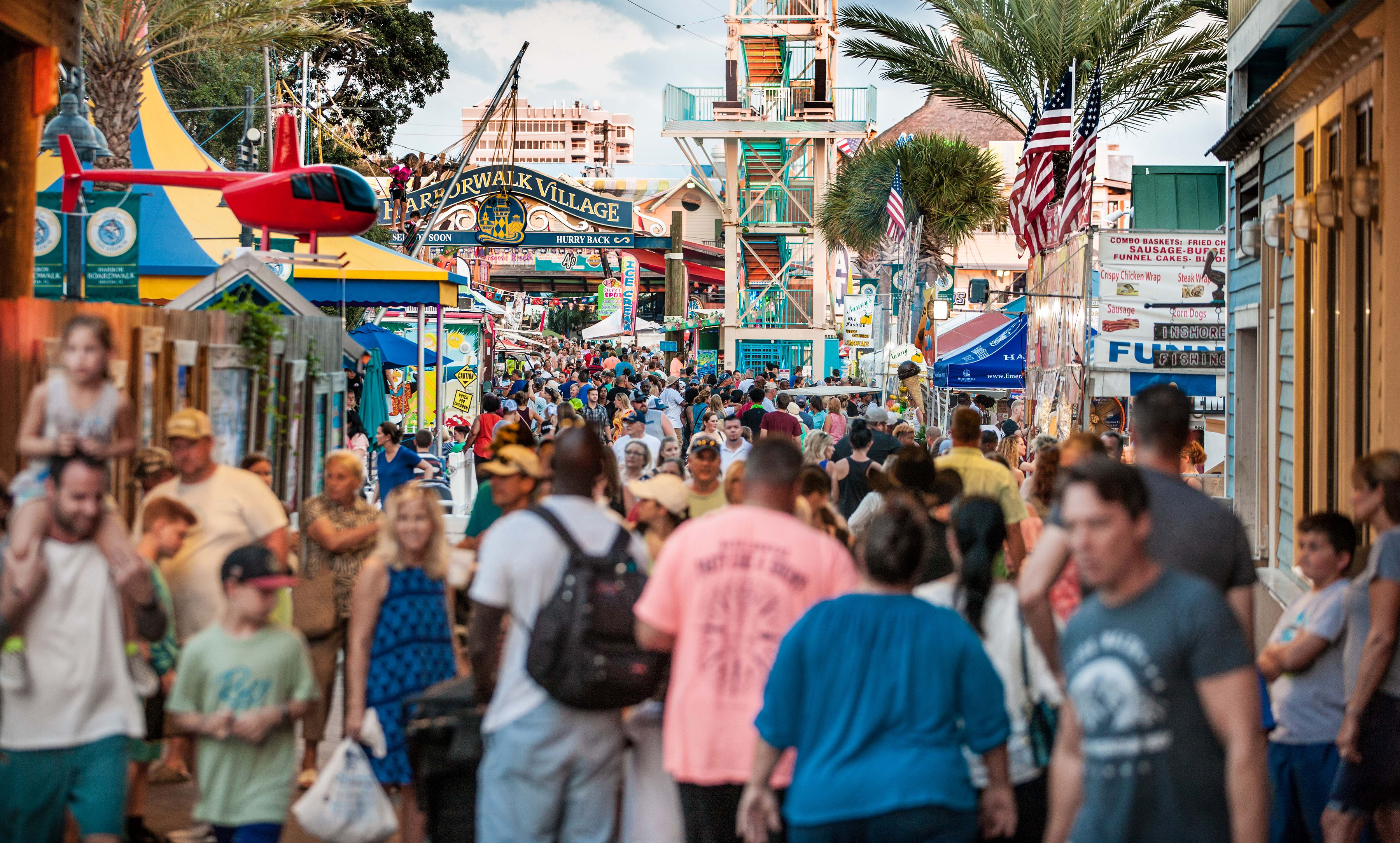 Visitors filling a lively pedestrian festival street