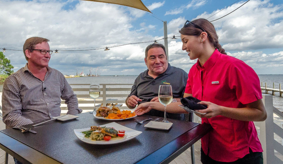 Couple enjoying dinner on a waterfront patio