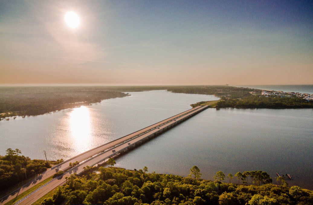 Aerial bridge crossing calm water in warm evening light