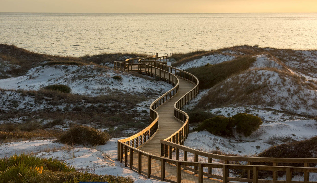 Curving dune boardwalk in soft sunset light