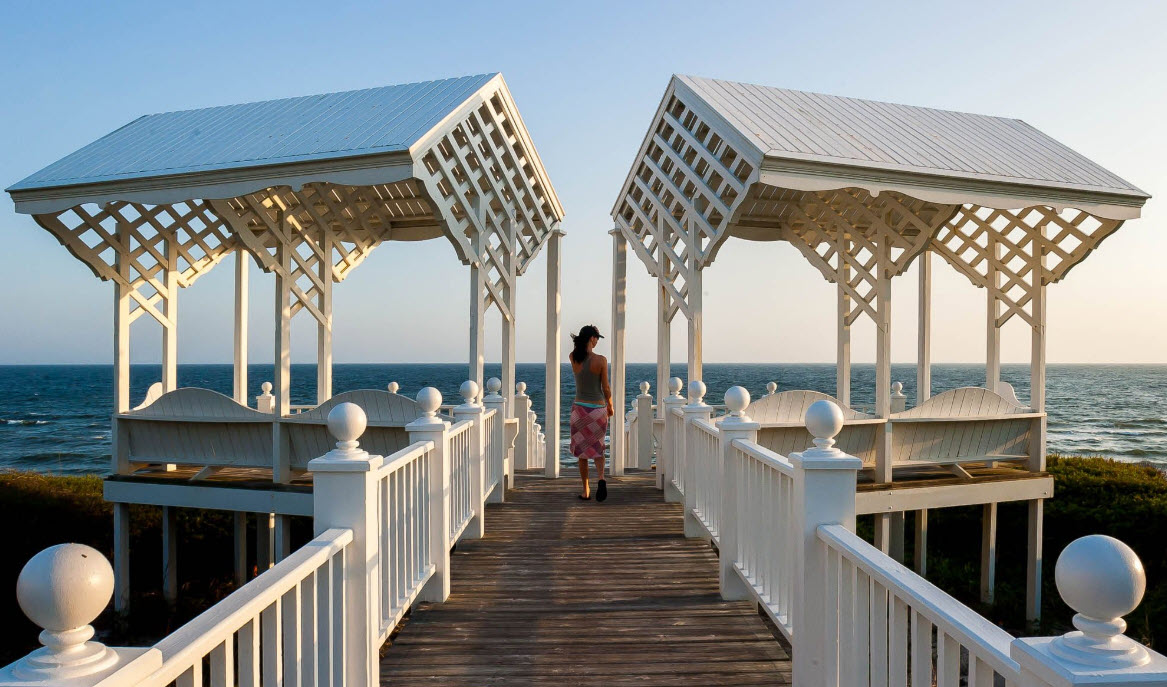 White pavilion at the end of a beach walkway