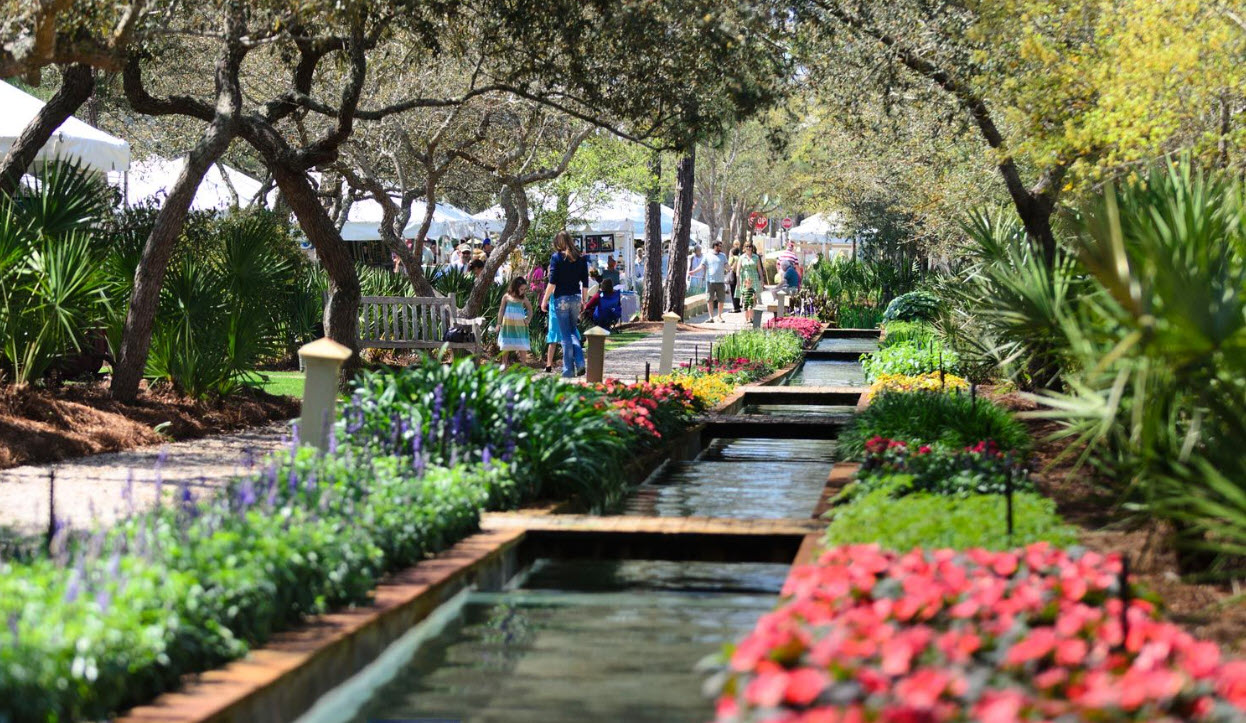 Flower-lined garden path beside a narrow waterway