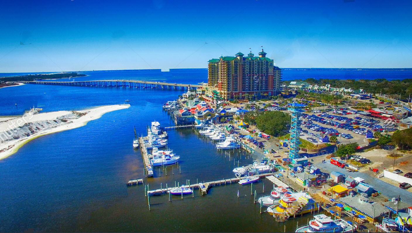 Aerial view of a marina, inlet, and waterfront buildings