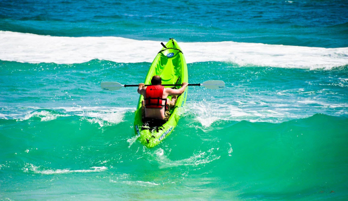 Jet ski rider climbing a turquoise wave