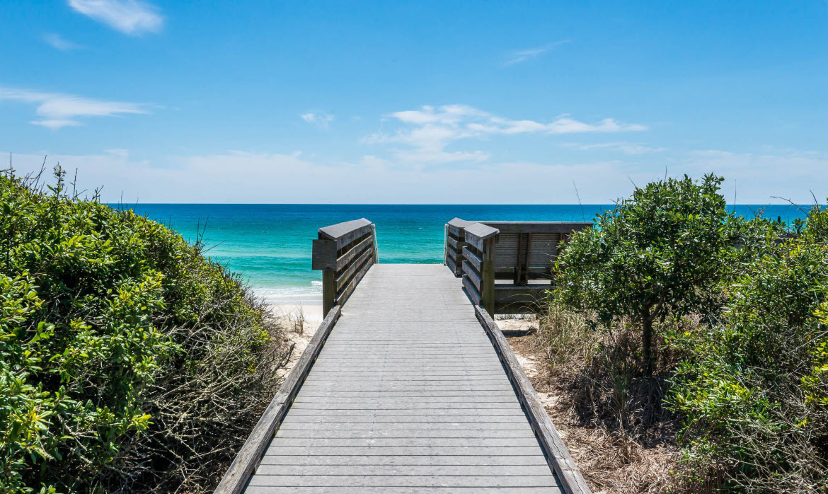Wooden boardwalk leading through dunes to the Gulf